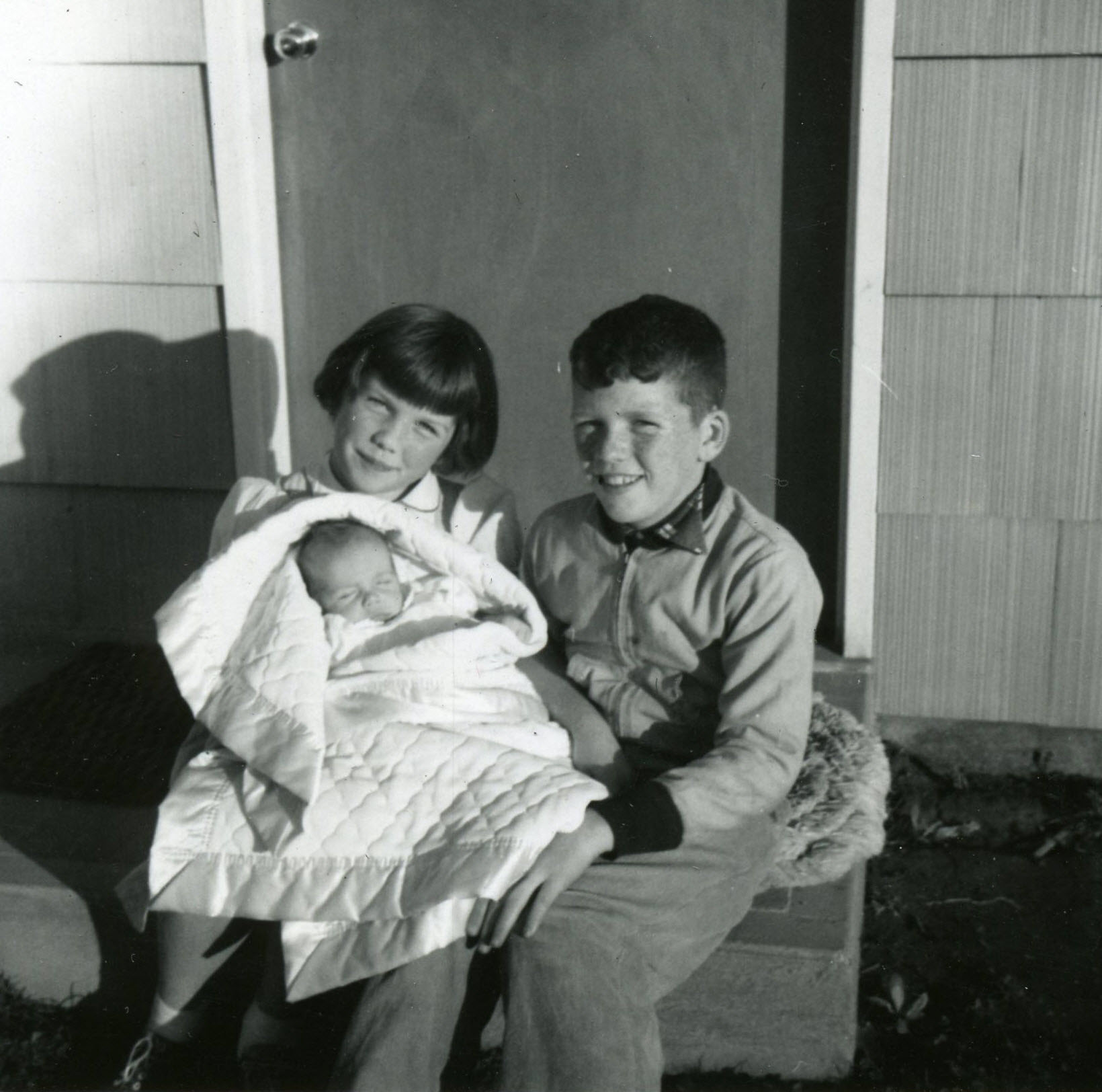 Bobby, Susan, and Mike on the porch of the new house.