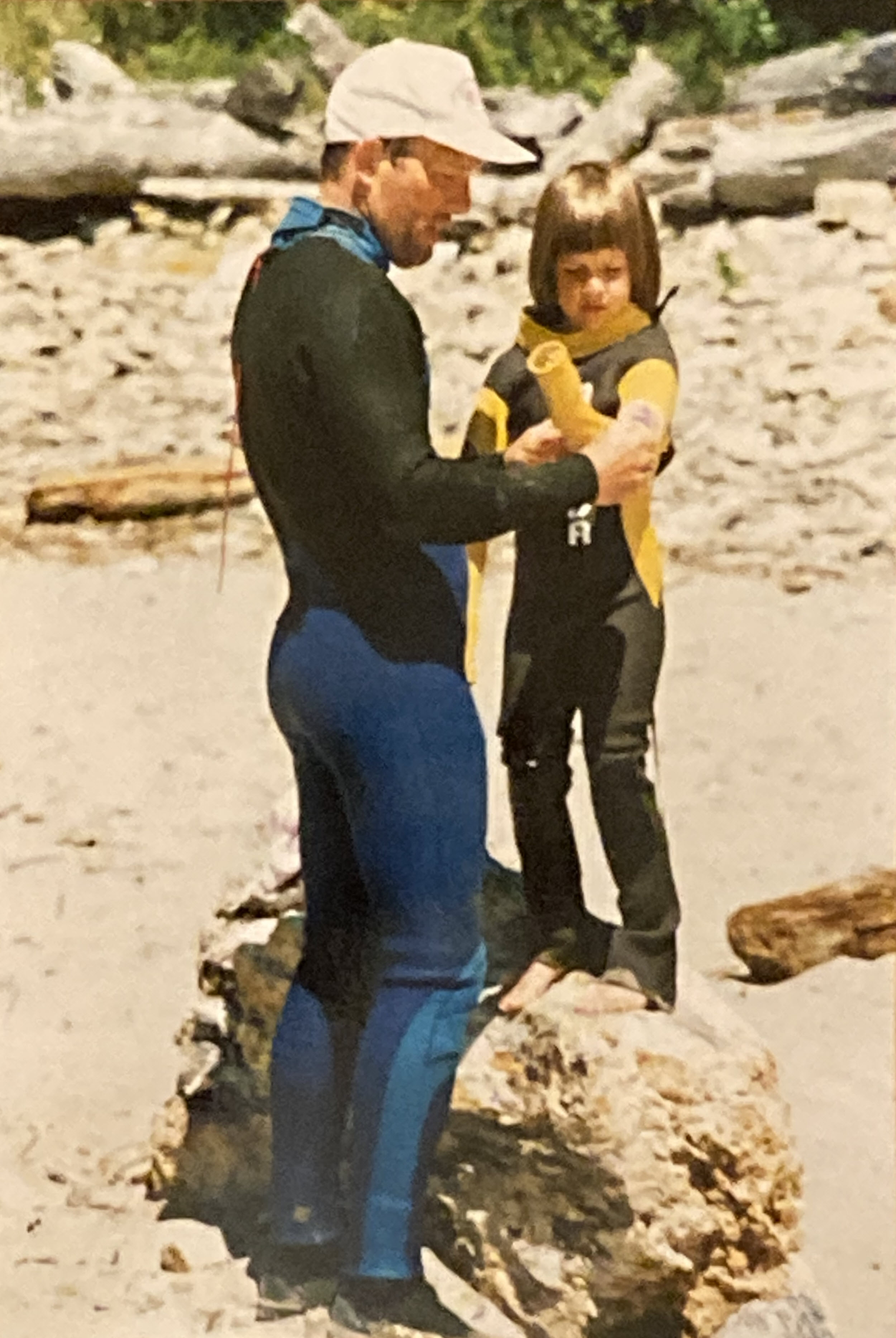 Mike helping Laura into her surfing wetsuit.