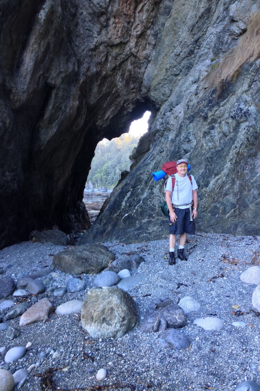 Peter at a hole in a rock wall.