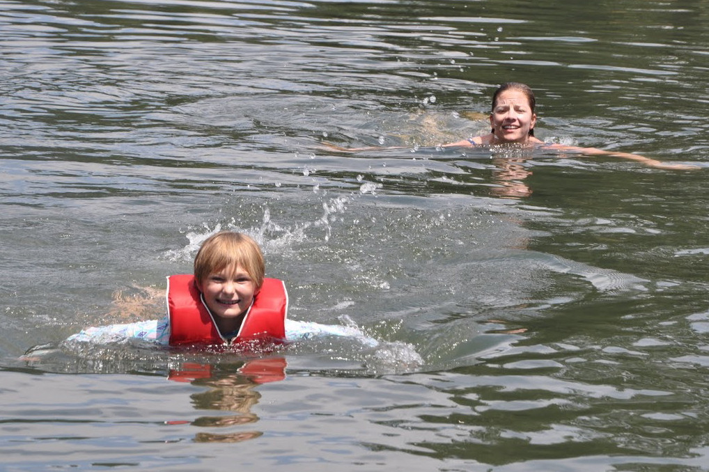 Maggie and Ella swim in the Deschutes River.