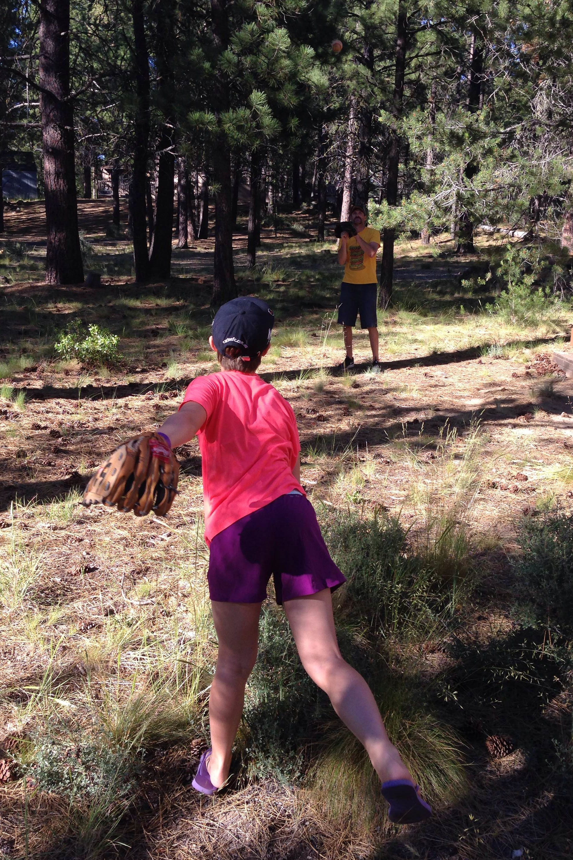 Ella and Damon play catch.